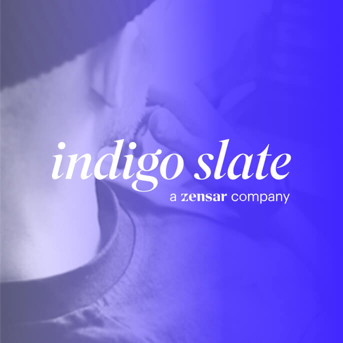 A person thinking seeing a laptop screen with the Indigo Slate logo on the side.